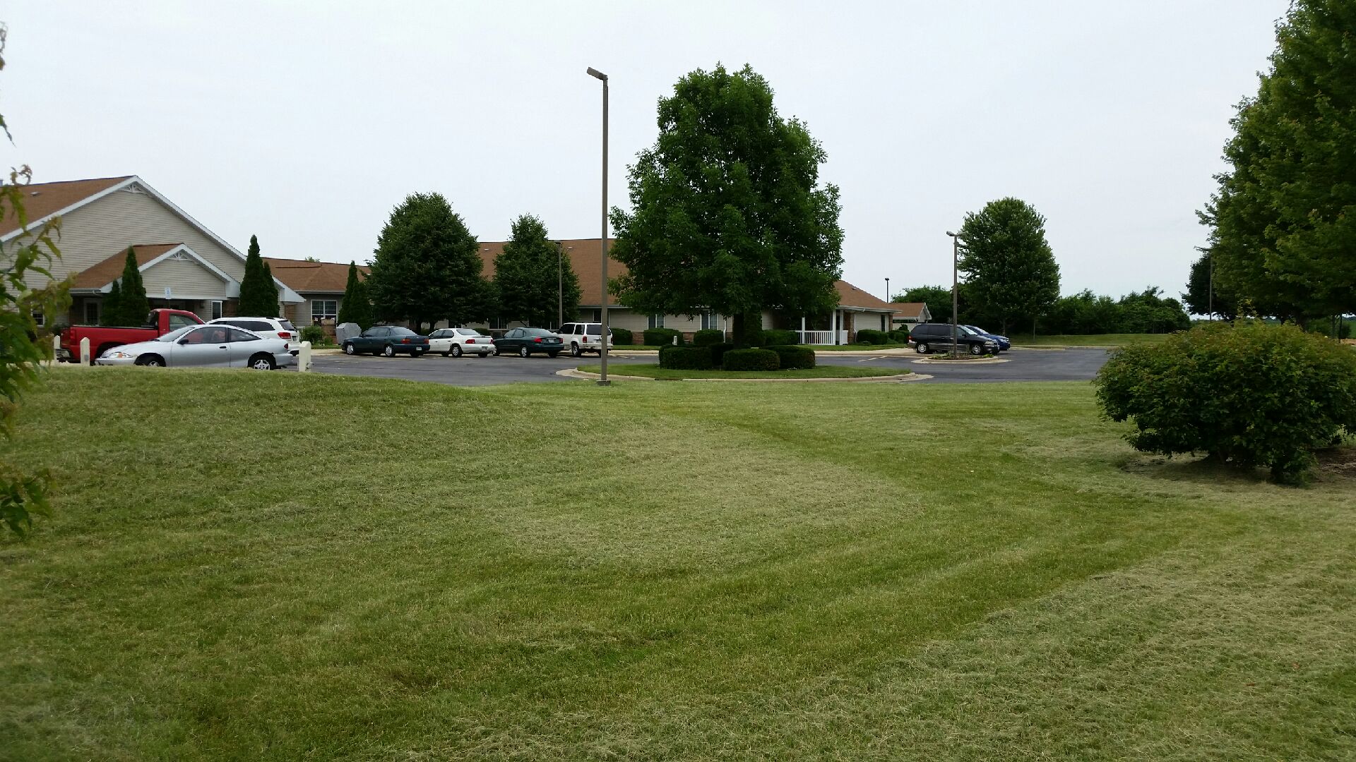 a lawn in front of a parking lot